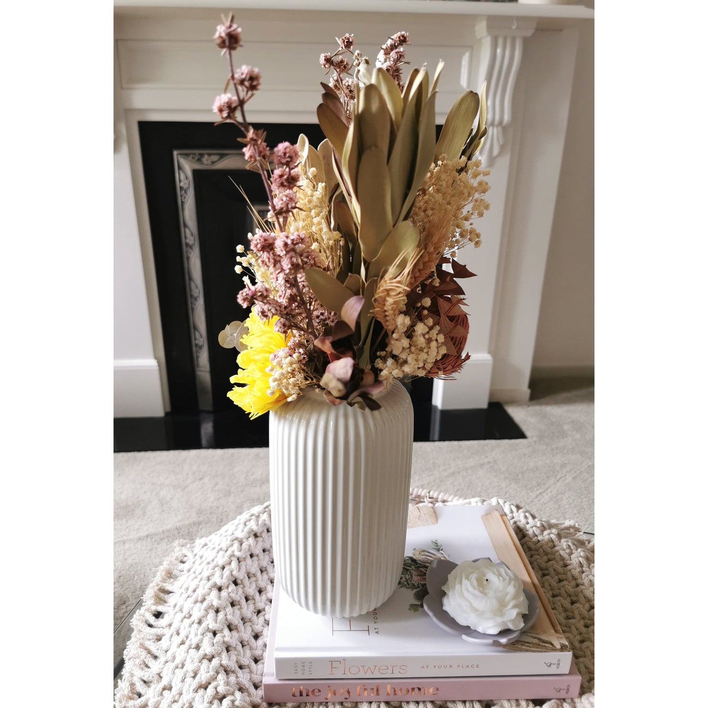Native dried and preserved flowers with a preserved sunflower in tall white ribbed gloss vase