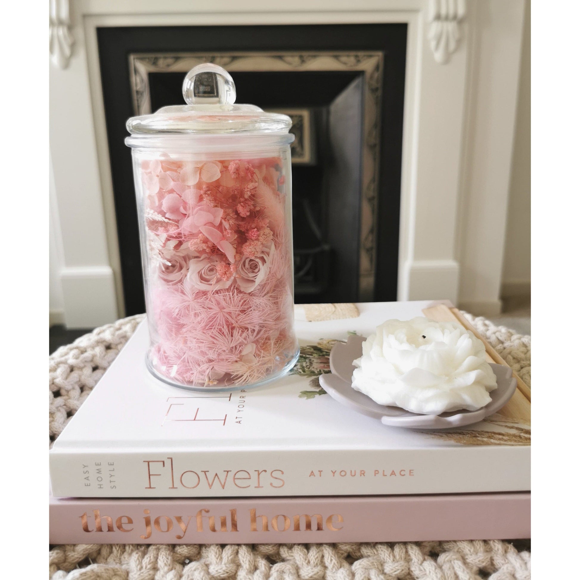 Dried and preserved flower offcuts known as flower confetti in a clear glass jar with lid